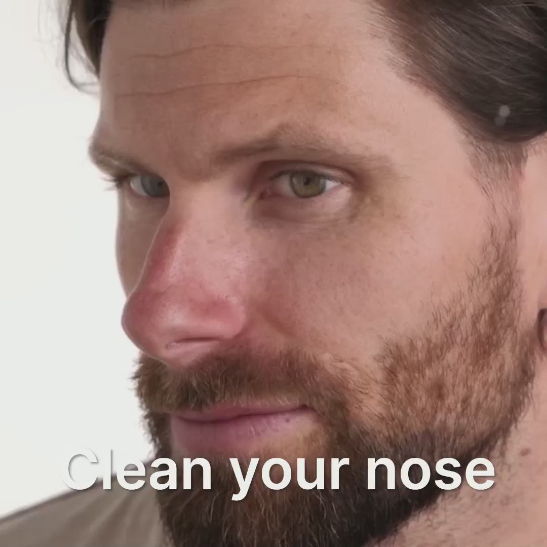 Close-up of a man with a beard, promoting nose cleaning for better snoring solutions.